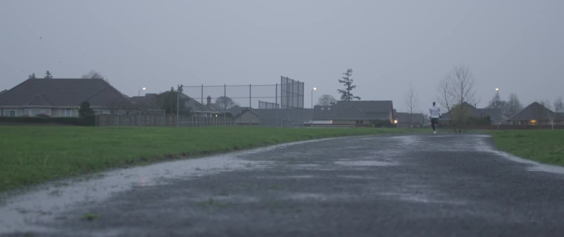 A man is running at dusk