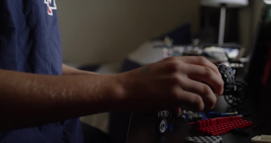 A boy is playing with his toys