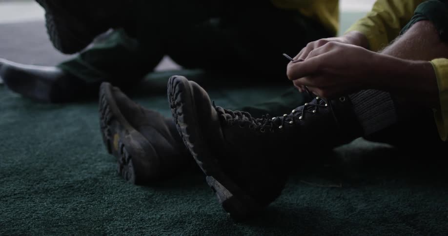People putting on combat boots