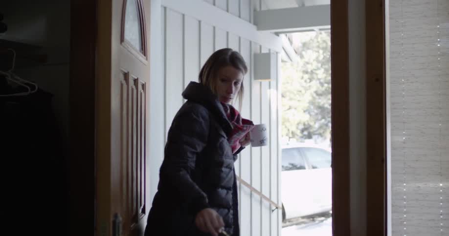 A woman is leaving their house