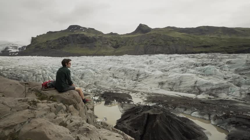 A person sitting on a rock