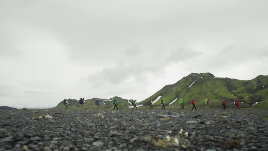 People are hiking across a volcano shield