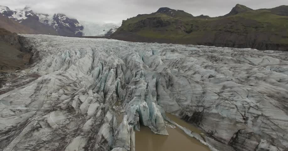 A glacier is shown at sunrise