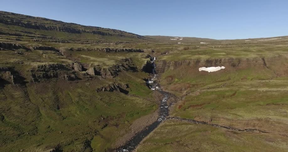The view is outdoors in the nature and you can see the river stream