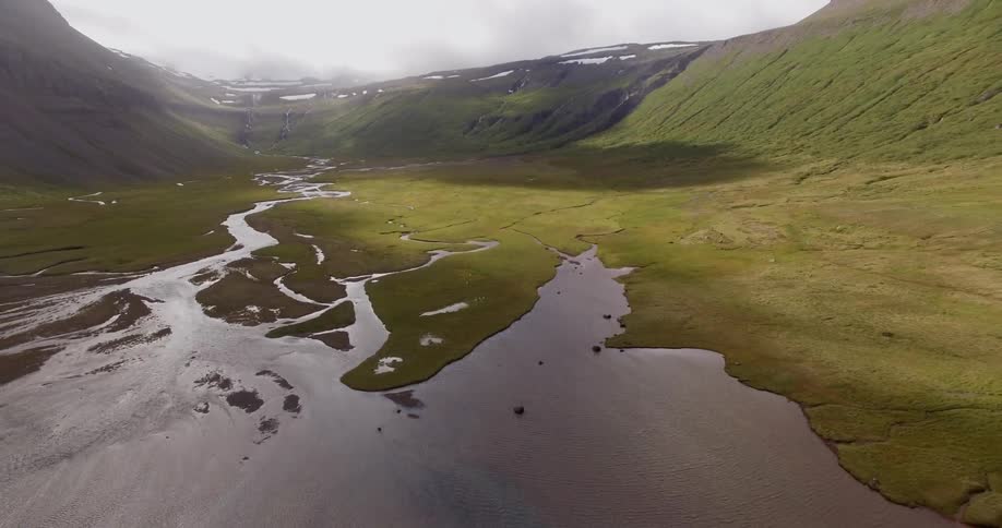 A lake is between the mountains