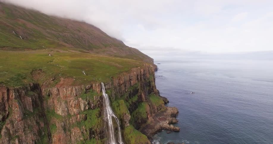 A plane flying above a cliff
