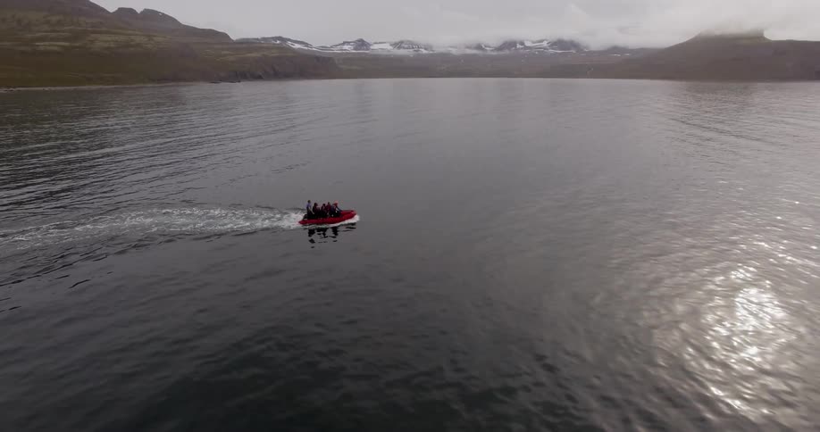 A boat is going a cross the lake
