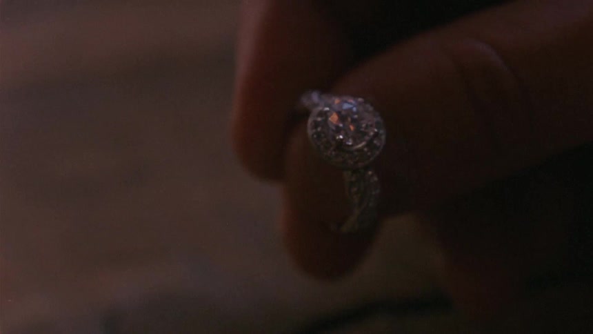A person holding a diamond ring