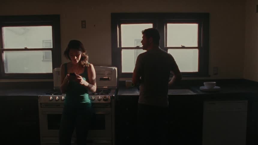 A man and woman arguing in the kitchen