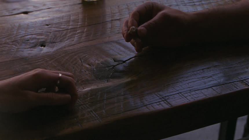 A woman returns a house key and an engagement ring to a man