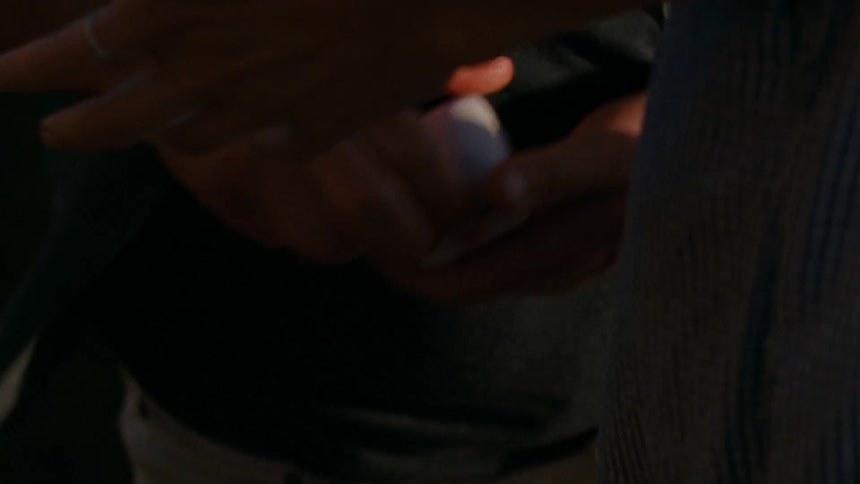 A man shows a woman a box with a ring in it