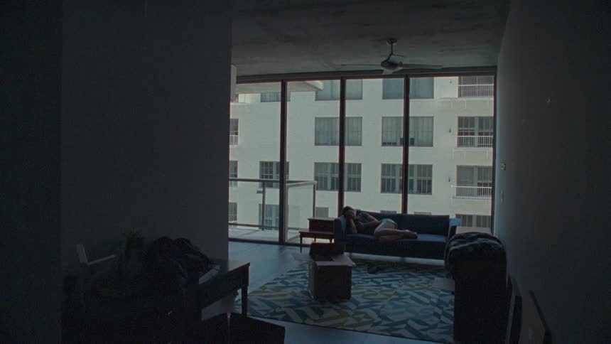 A living room with a woman  laying down