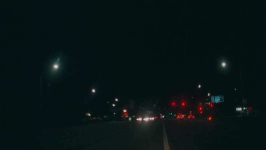 A street is shown at night