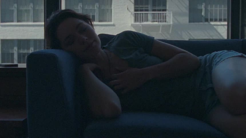A woman laying on a couch