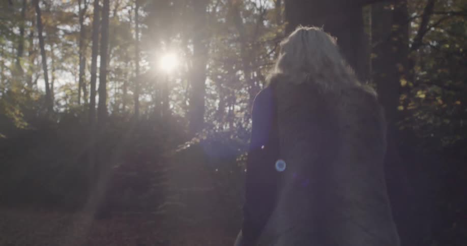 A woman walking in a wooded area