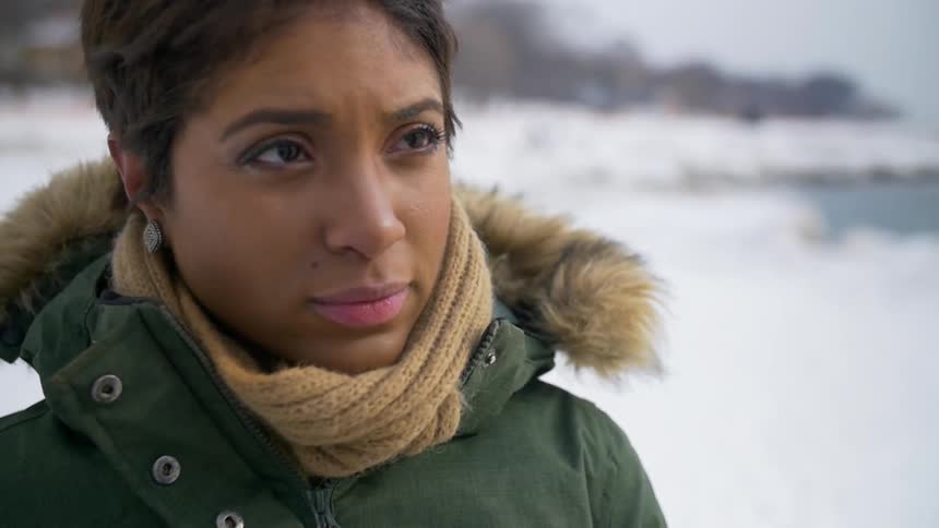 A woman is standing in the snow