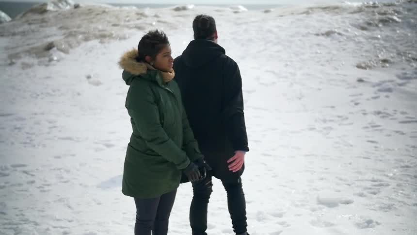 Peopel are standing in teh snow