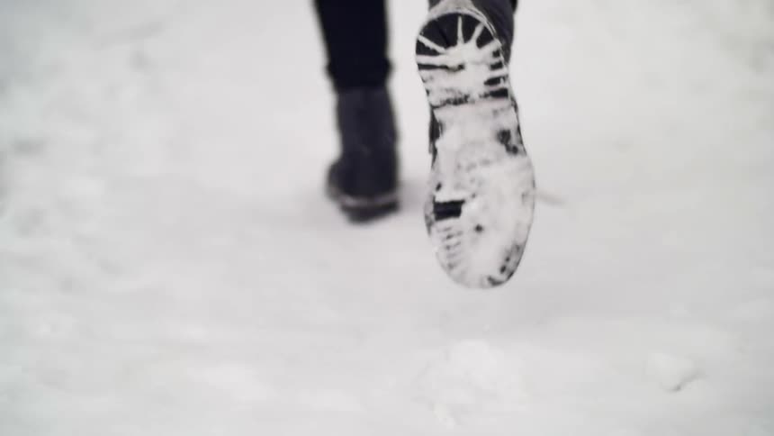 Boots walking through snow