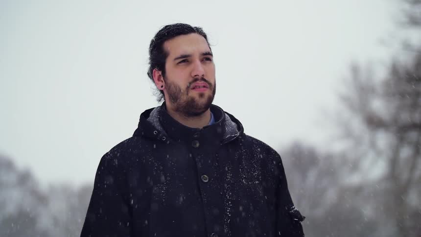 A man standing outside in the snow