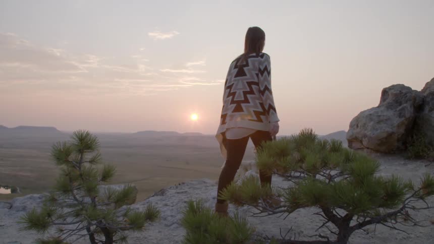 A woman is walking in the desert