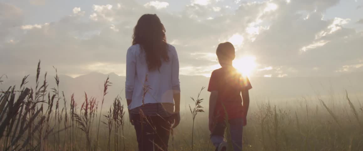An adult walking with a child