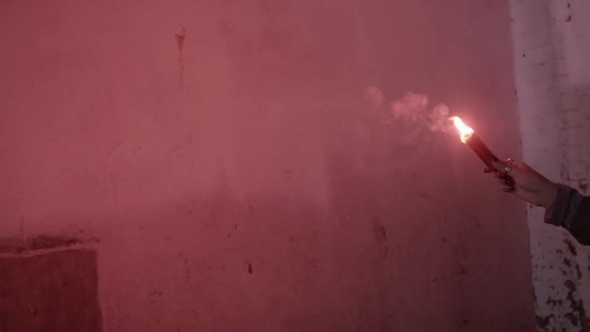 A flare going off, lighting a previously dark room