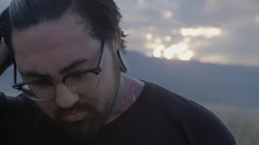 A man rubs his head in deep thought over something