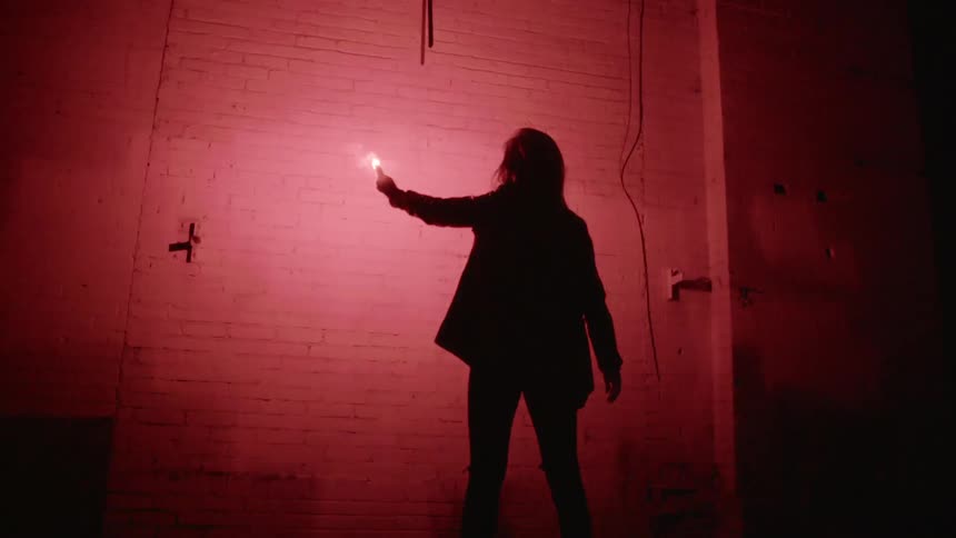 People With Flares In Abandoned Building