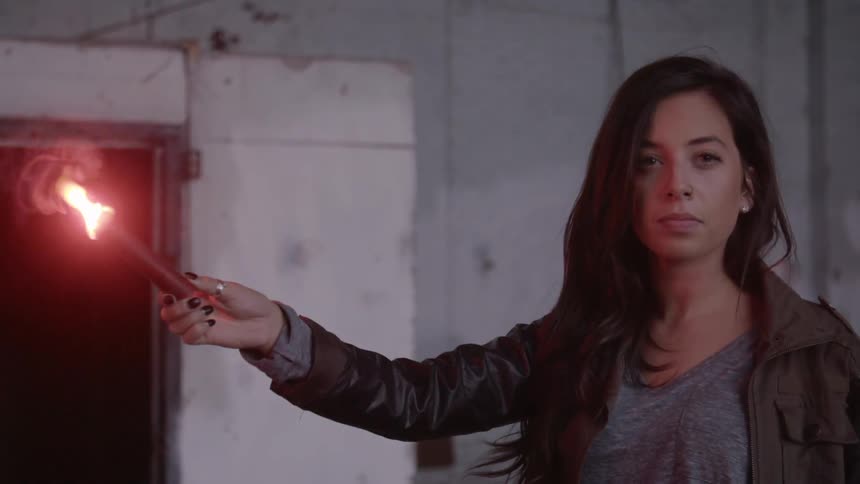 A woman holding a flare