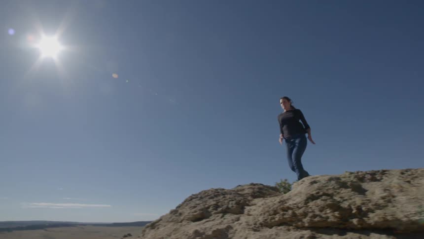 A woman is running down a cliff