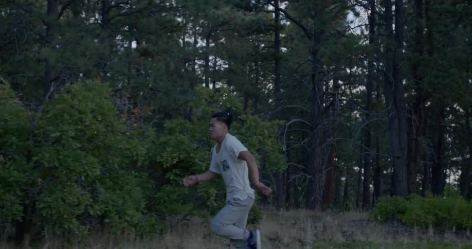A man is running through the woods