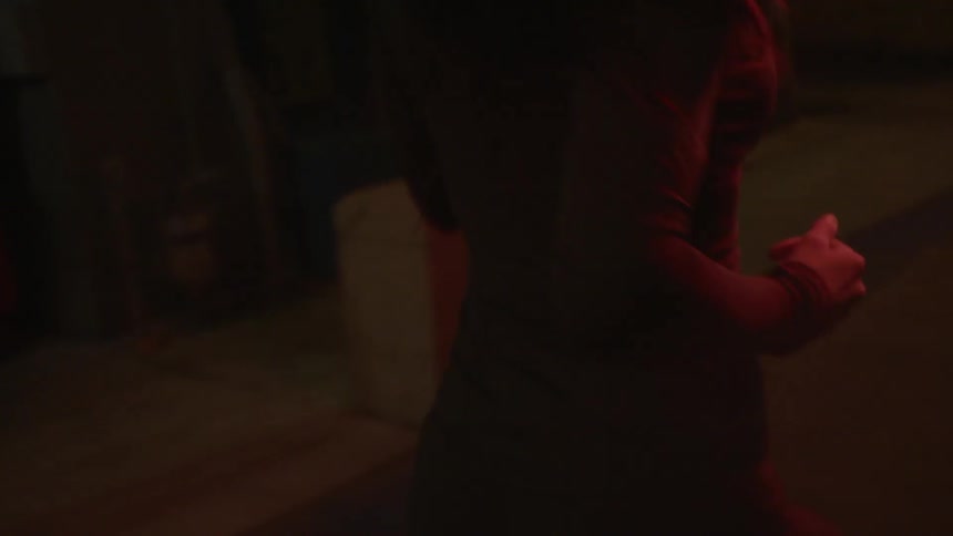 A woman running in a city area at night