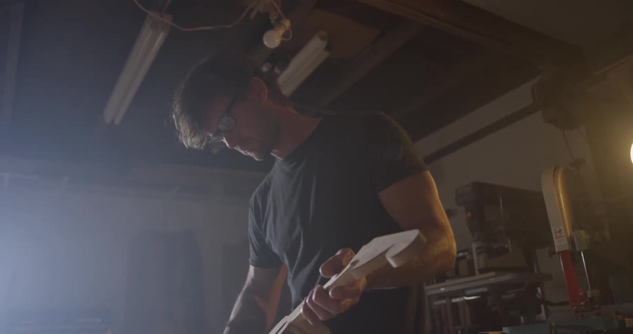 A man that is working on building a guitar