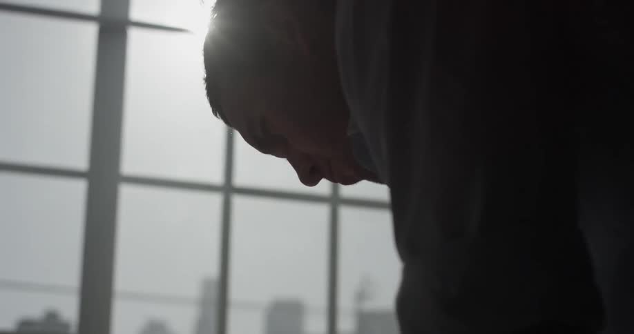 A man looking at a piece of paper on a desk