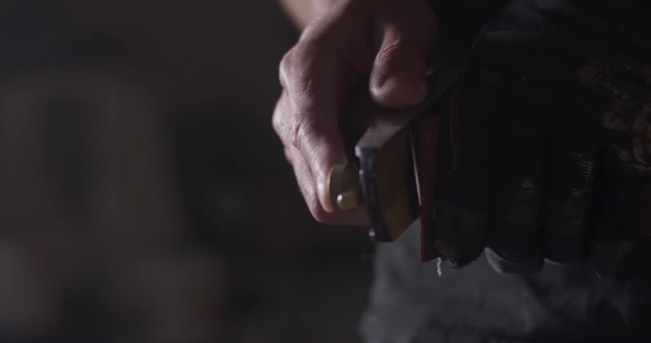 A person using a plane on a piece of wood