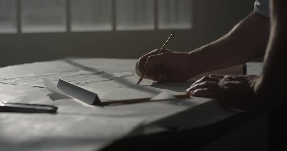 A man is writing on a piece of paper
