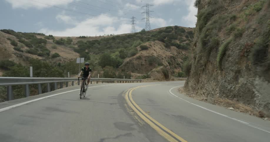 A man riding a bicycle up a mountain
