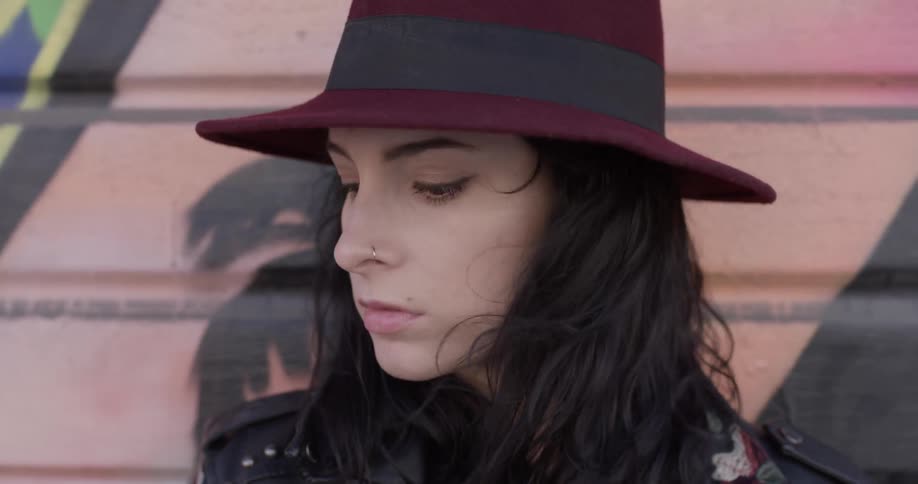A woman is wearing a hat outside