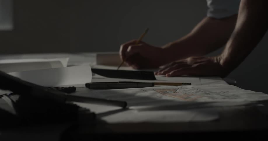 A person that is sketching on a piece of paper
