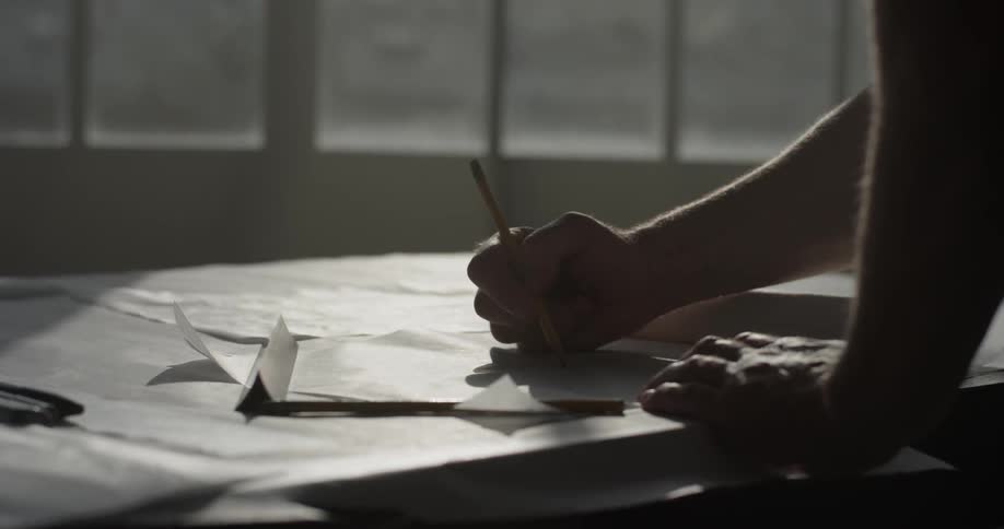 A woman is writing something on paper
