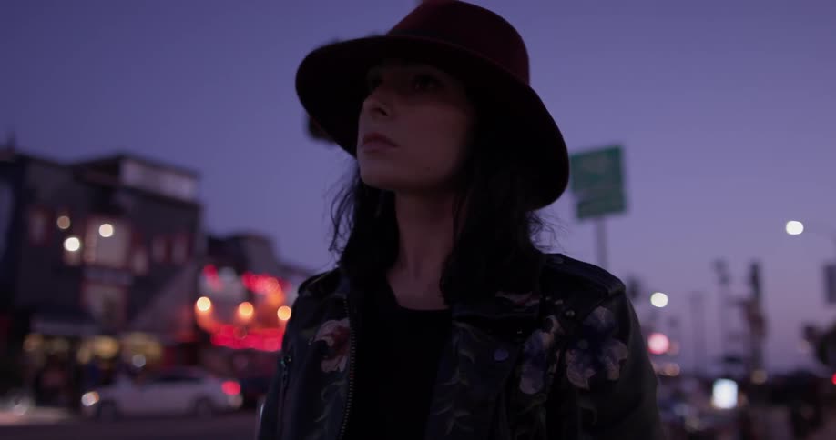 A woman looks around the street surroundings