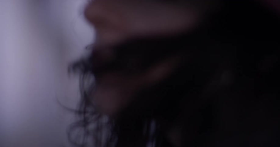 A woman is outside wearing a hat