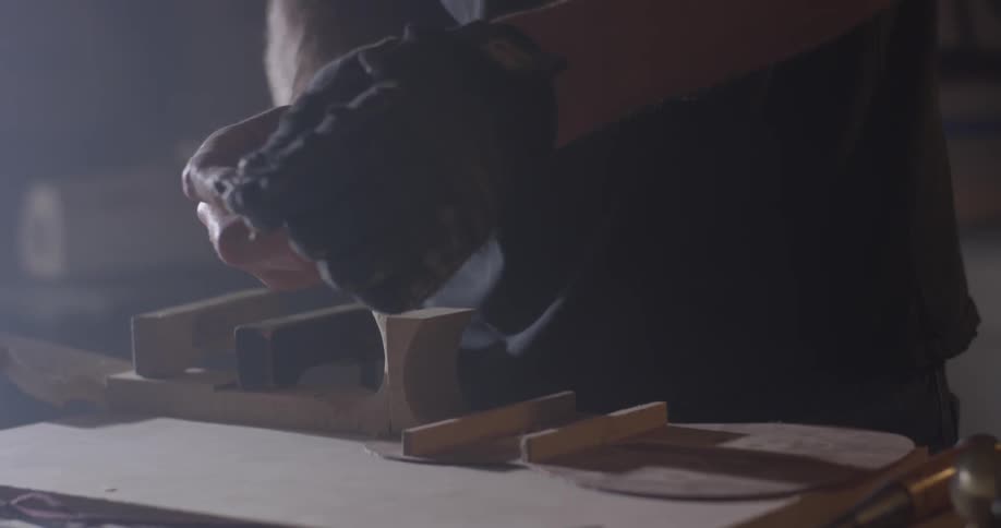 Woodworker repairing an item on his table
