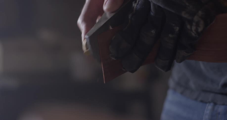 Carpenter Making Guitar In Workshop