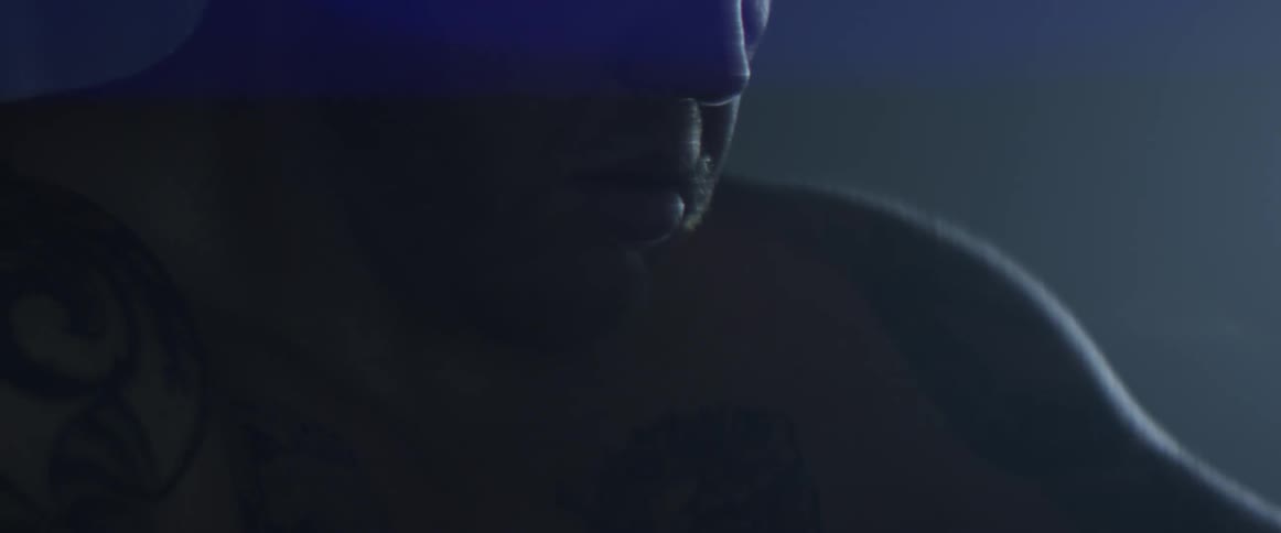 A man frowns in the darkness
