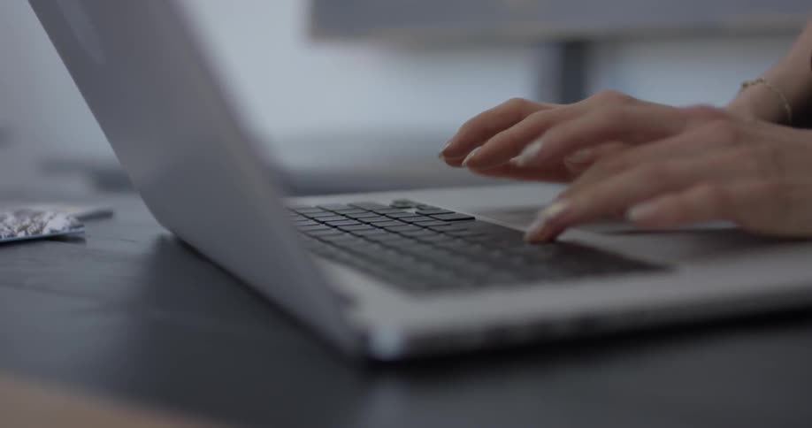 Person types on a laptop