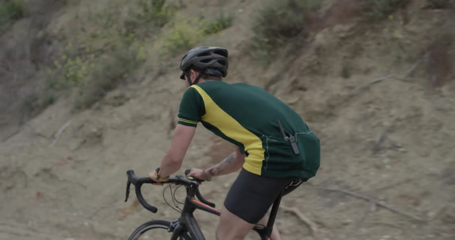 Man riding on a bicycle along a path