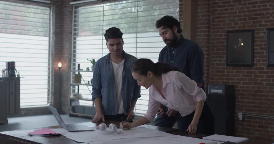 A group of people are having a discussion around a table
