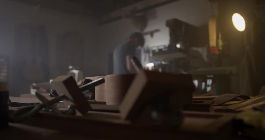 A man working in a wood shop on a project