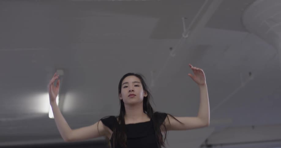 A woman twirls as she dances a complicated dance routine
